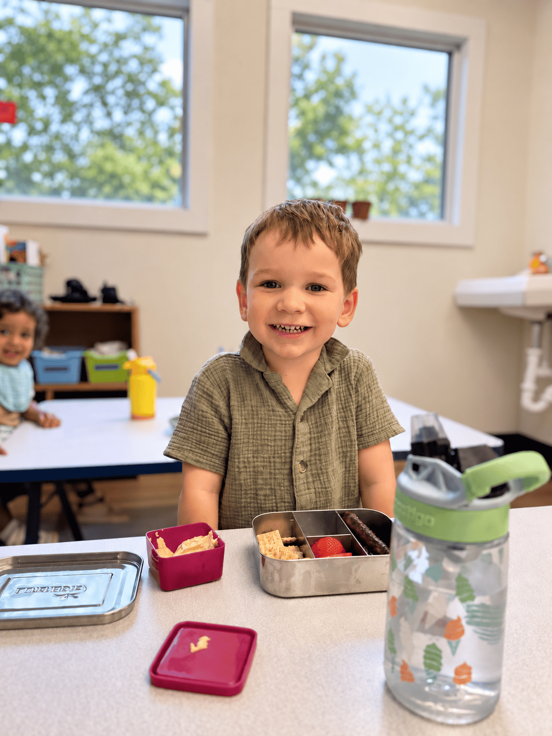 Teacher reading a book with preschool children gathered on a classroom rug